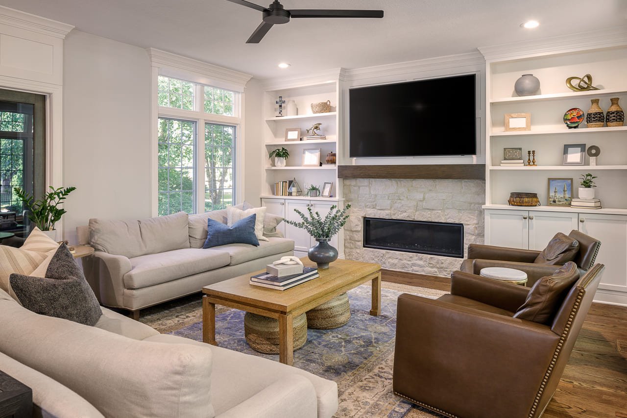 Living Room with Custom Built-in Shelving Surrounding Fireplace with Natural Stone | Compelling Homes Remodeling + Design