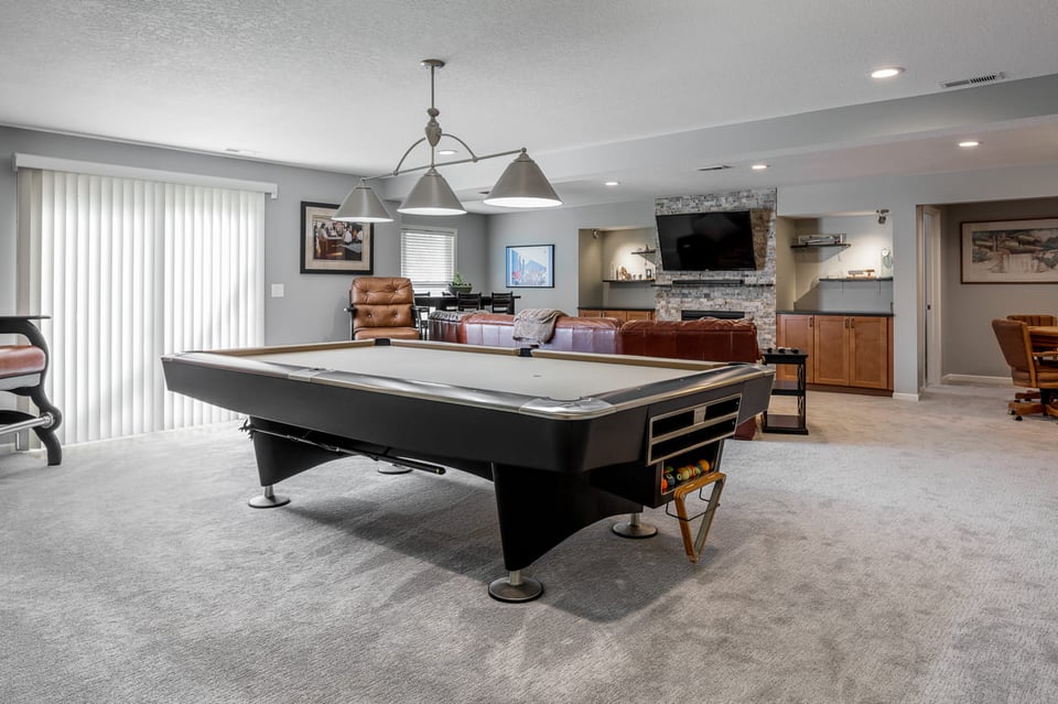 A poker table fitted in a walk-up or walk-behind basement bar