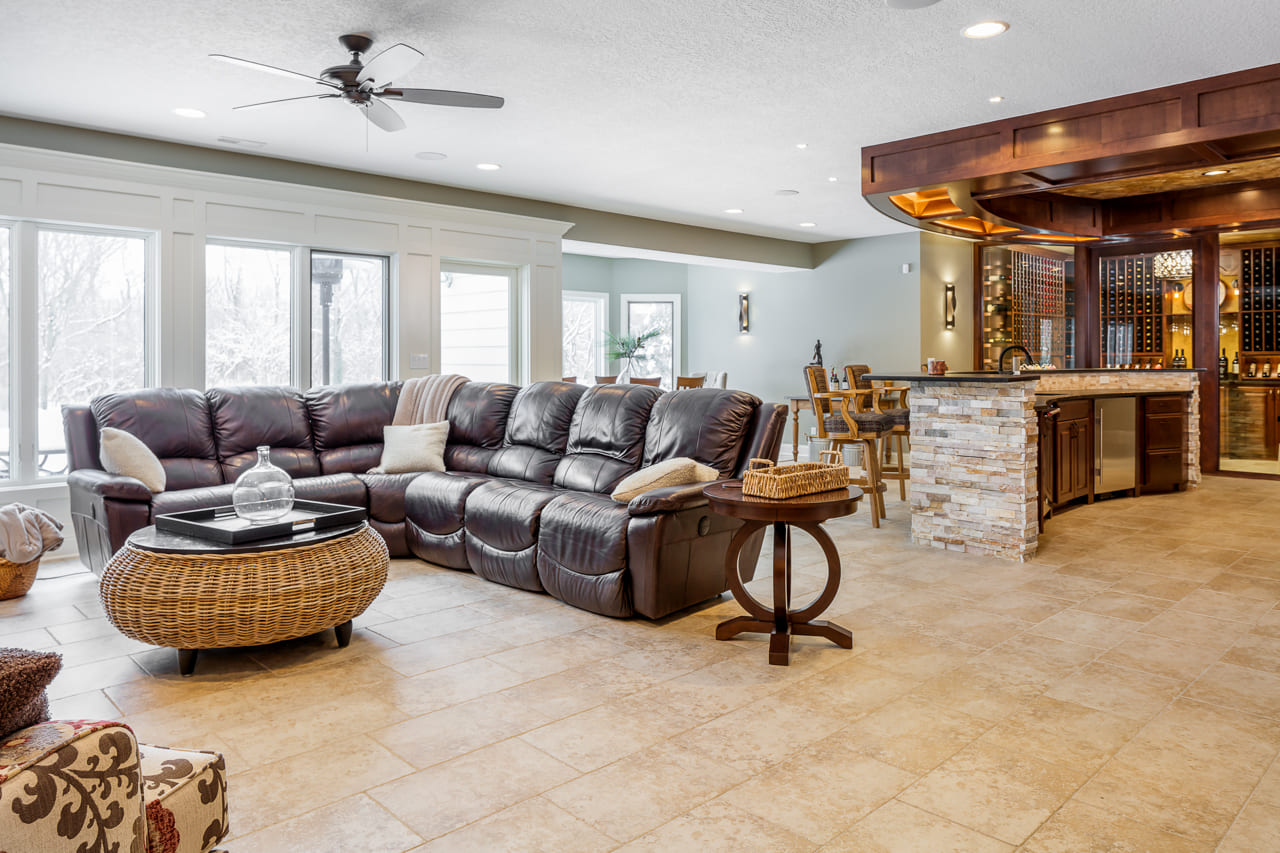 Sitting area in a basement with floor-to-ceiling windows for natural lights