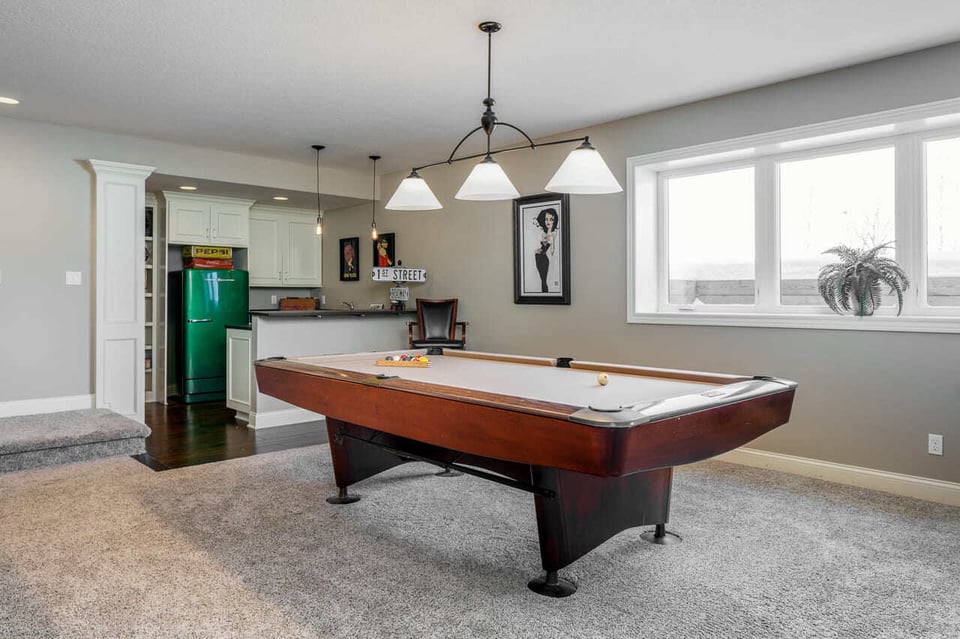 Classic pool table pendant lighting in a basement