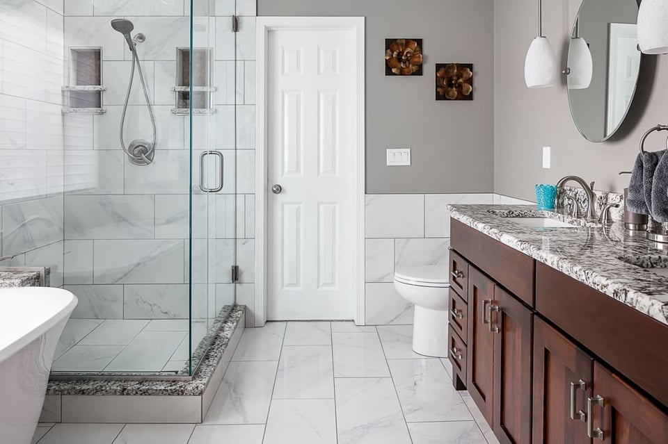 Hall bathroom showing ceramic floor tiles and white painted wooden door