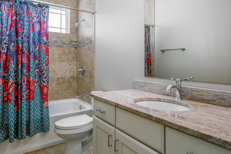 Curtains Installed Over A Shower En-Suite In A Bathroom - Spare Bathroom Remodeling Ideas | Compelling Homes