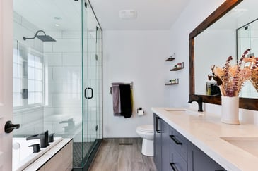 A hall bathroom with full bath and toilet. Fitted with hardwood floors