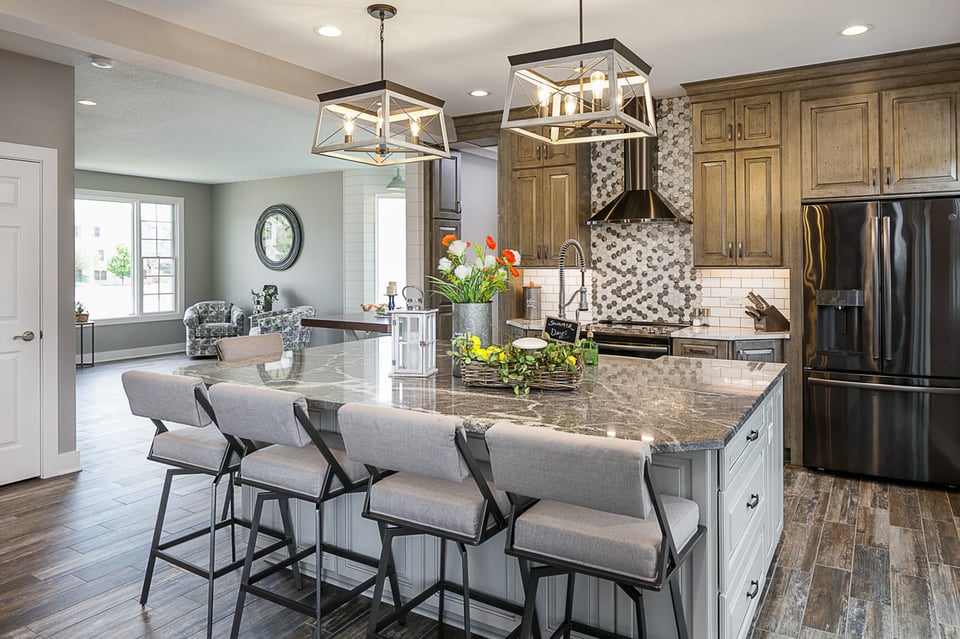 Full After Kitchen Remodel with Light Wood Cabinetry and Dark Grey Counter Tops