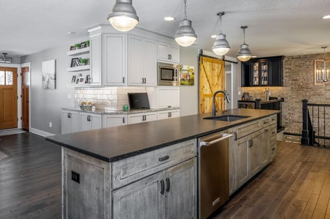 Whole Home Remodel Kitchen Hallway to Mudroom with Sliding Barn Door and Walk Up Bar with Subway Tile and Stone Accent Wall | Compelling Homes