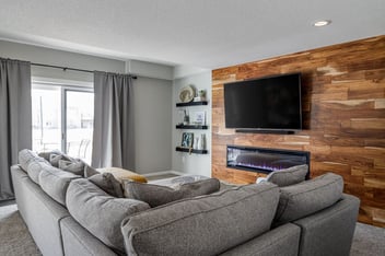 Basement Remodel Hardwood Flooring Accent Wall with Built-In Electric Fireplace Lots of Natural Light and Gallery Wall | Compelling Homes Remodeling & Design