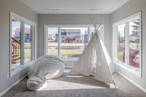 Basement Remodel with Play Area for Kids Natural Light Large Windows Overlooking Backyard and Pond | Compelling Homes Remodeling & Design