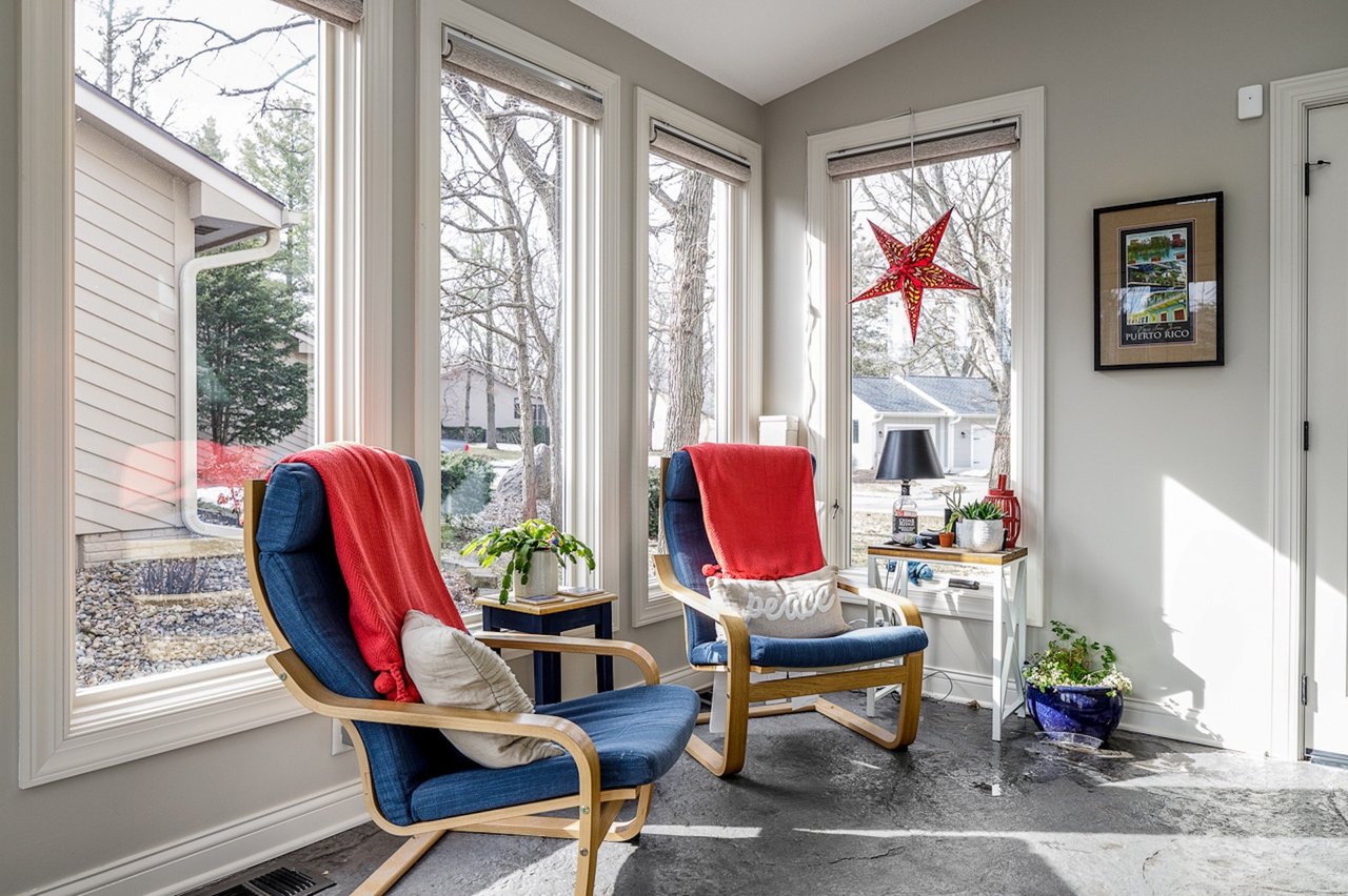 A sunroom with blue wooden relaxing seats