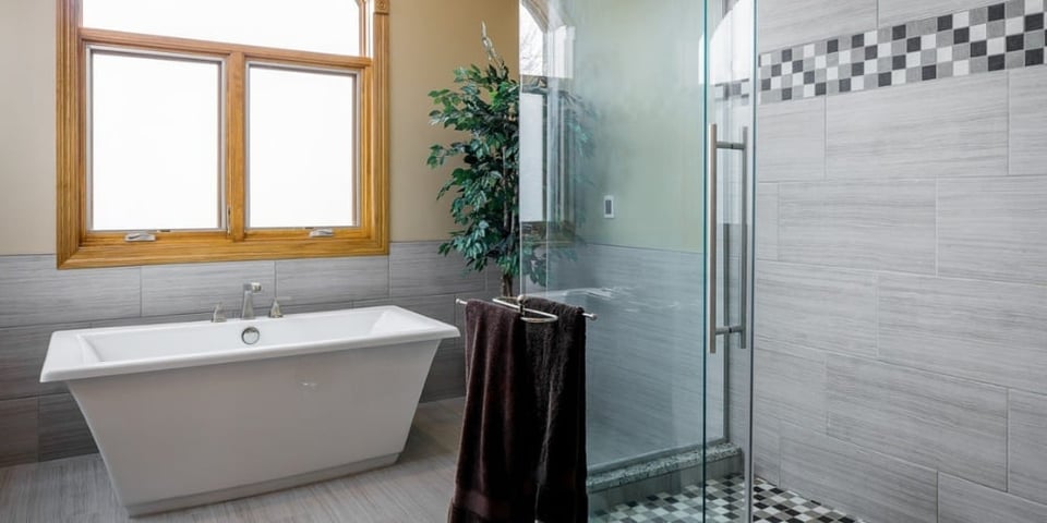 How Much Does a Bathroom Remodel Cost in Des Moines? | Freestanding Tub and Walk-In Glass Shower in Modern Bathroom | Compelling Homes, Des Moines, IA