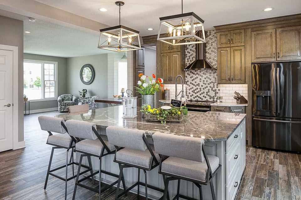 Large serene kitchen fitted with porcelain floors and pendant lights