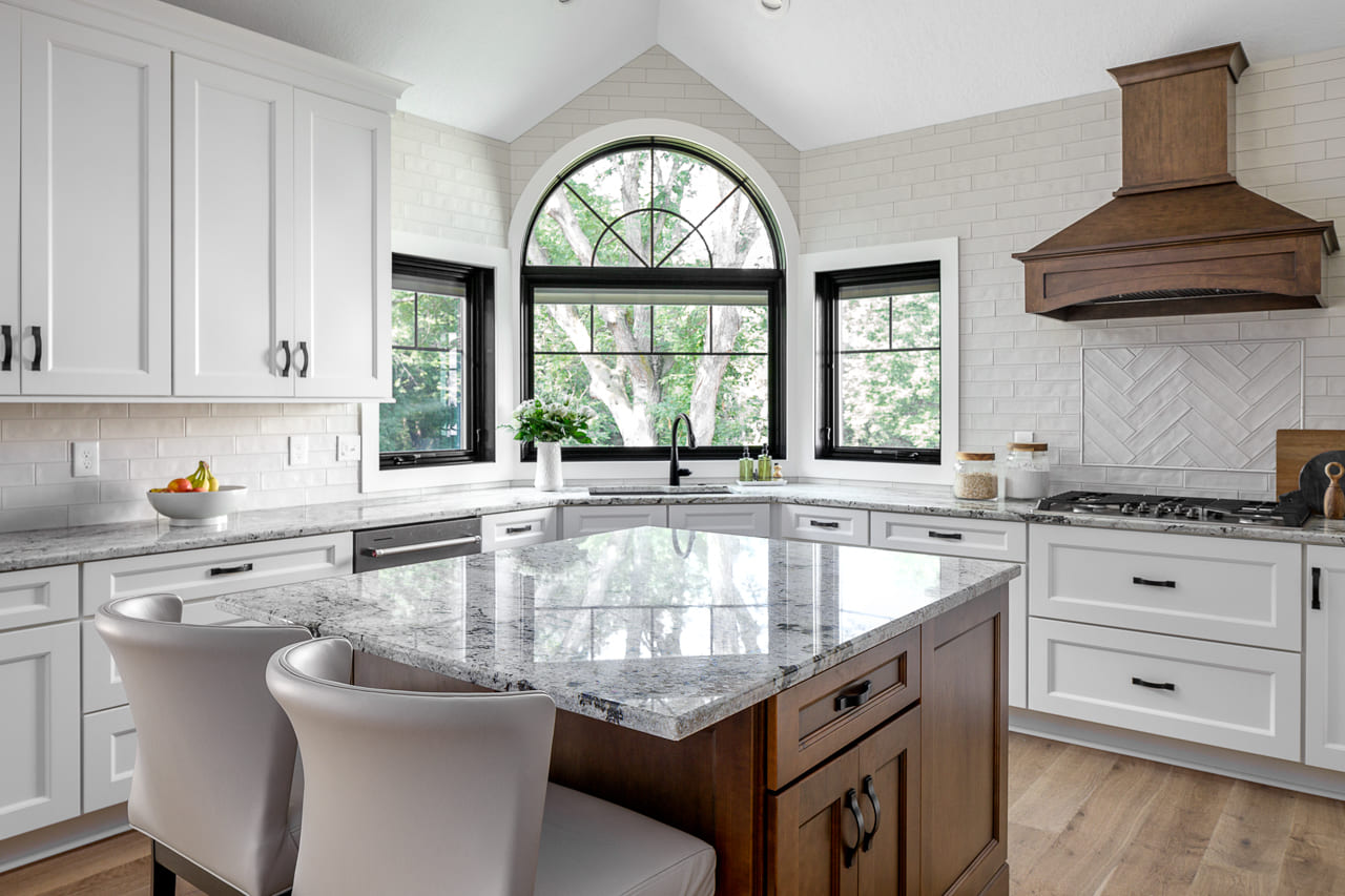 White Kitchen with Decorative Glass Subway Tile White Cabinets and Island Seating | Compelling Homes Design Build