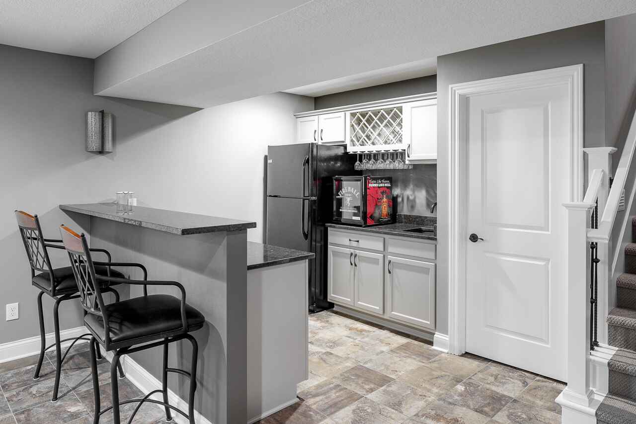 a half kitchen with stone tile flooring