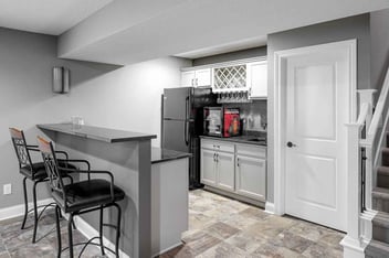 a half kitchen with stone tile flooring