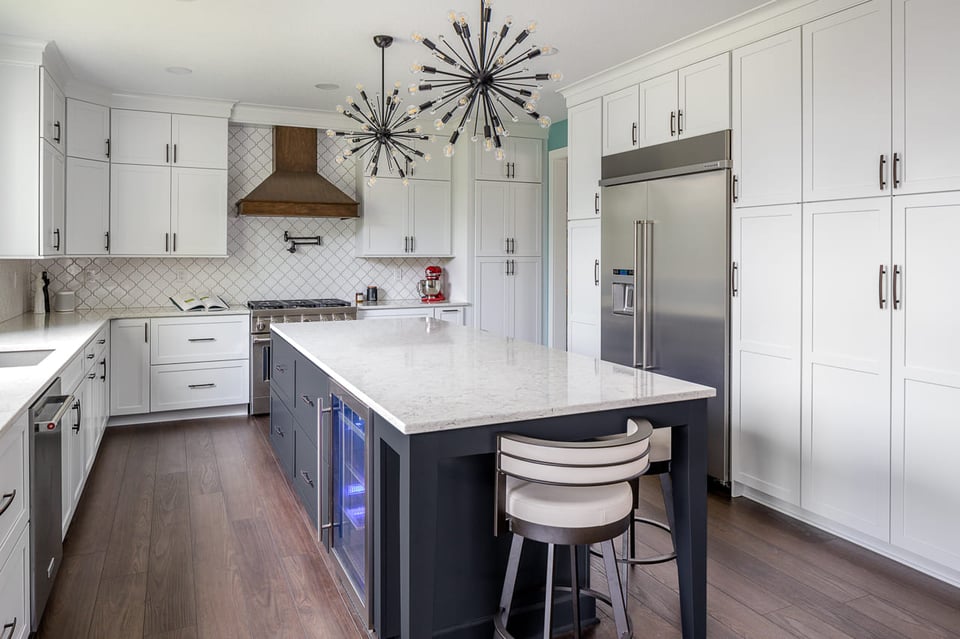 Full View of White Kitchen with Navy Blue Kitchen Island and Unique Kitchen Lighting | Compelling Homes