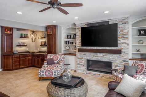 Custom Buffet Area and Living Room with Stone Accent Wall and Custom Built Ins | Compelling Homes Des Moines, IA