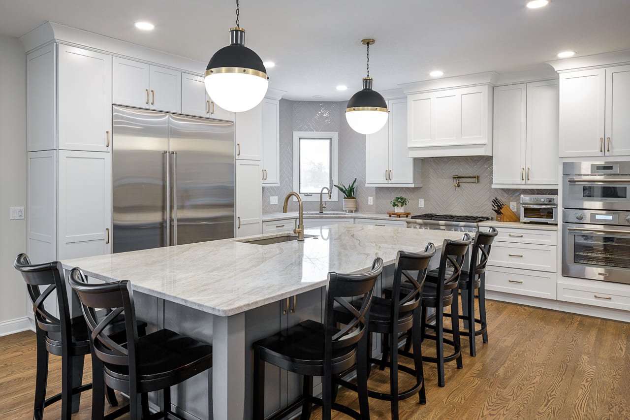 Modern and Bright Kitchen with Eat-in Island featuring Prep Sink and Built-in Fridge and Pasta Filler Above Stovetop