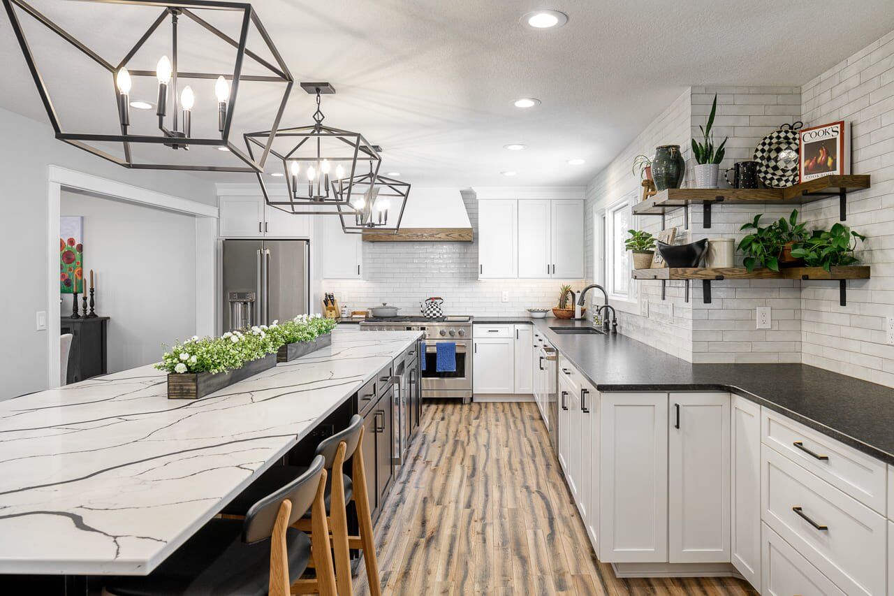 Large Kitchen with Eat-in Oversized Island featuring Custom Floating Shelving and Glass Subway Tiles